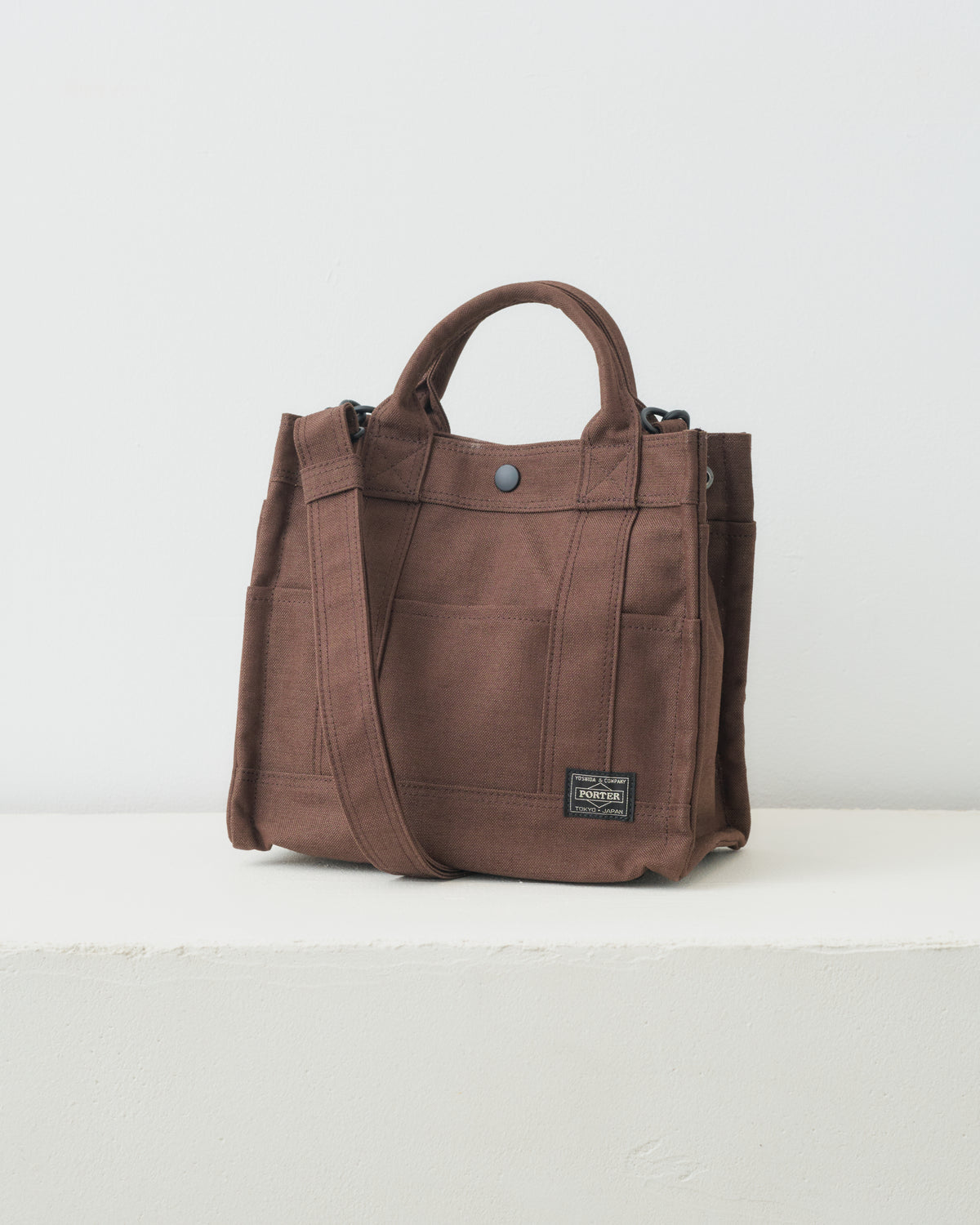 Porter Yoshida & Co. Smoky 2Way Tote Bag (S) in brown, three-quarter view with shoulder strap