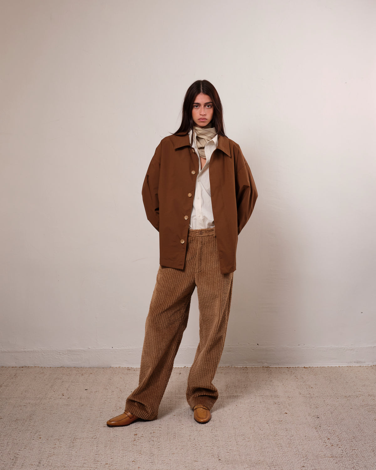 Colbo Wide Cord Chinos in dark tan wide-wale corduroy, on model, worn with a brown jacket