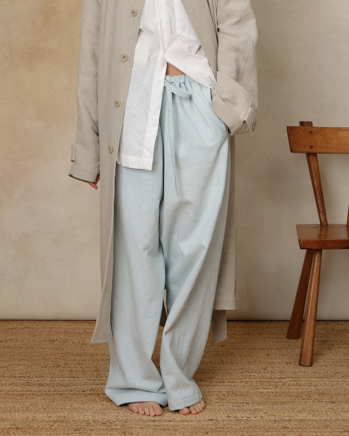 Colbo Farm Pants in summer blue cotton, on model, worn with a long coat