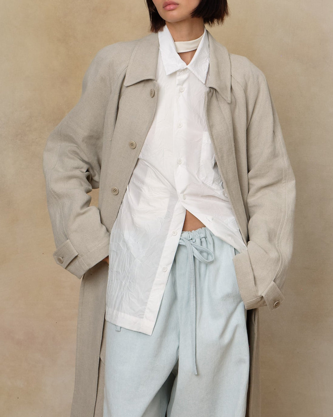 Colbo Crinkled Shirt in white textured cotton, on model, worn under a long coat