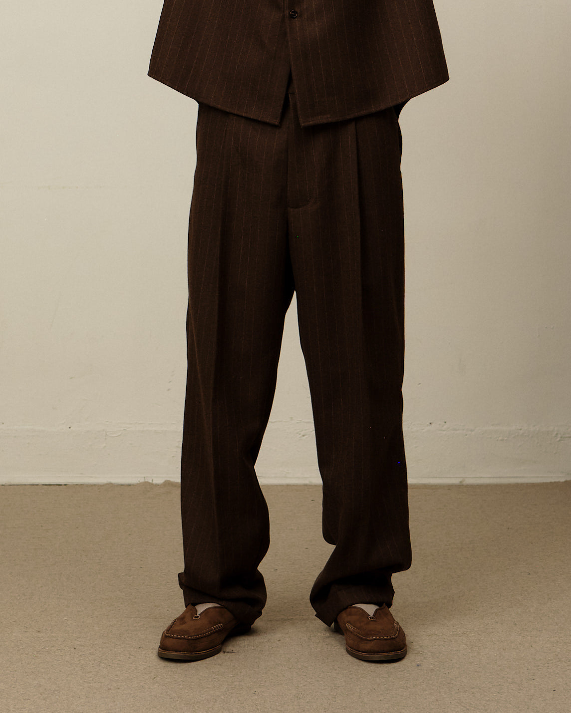 Model wearing brown pinstripe Colbo Beverly pants.
