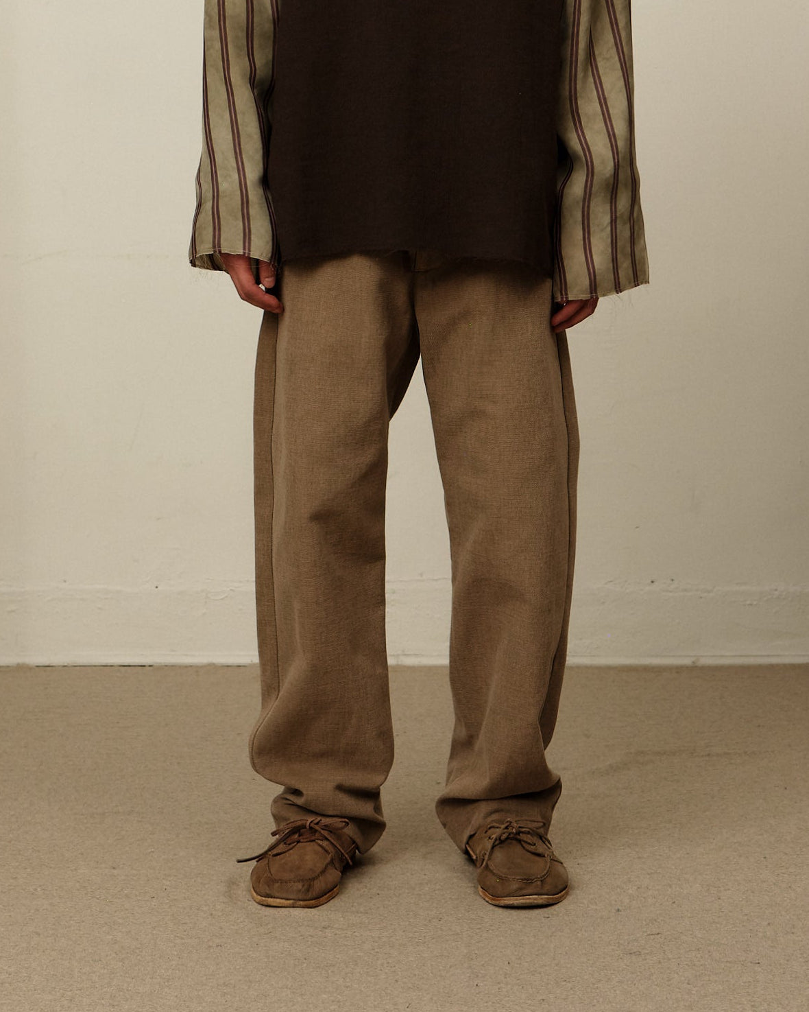 Colbo Chinos in brushed brown canvas on model, front, with a striped shirt and suede shoes