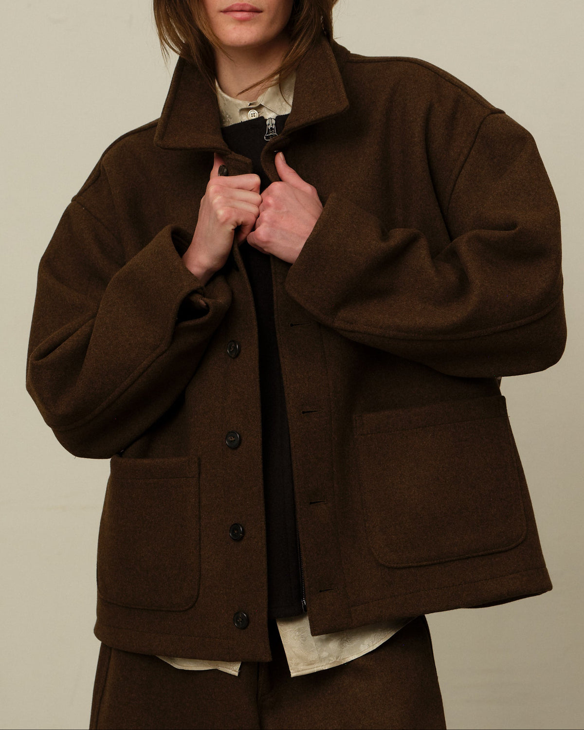 Colbo Steam Jacket in brown on model, front, collar held closed