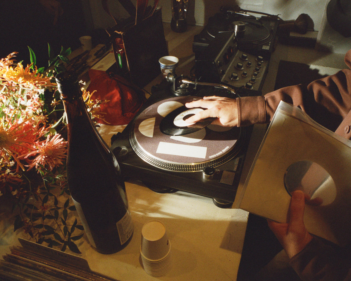 Records spinning beside flowers and natural wine at a Colbo party