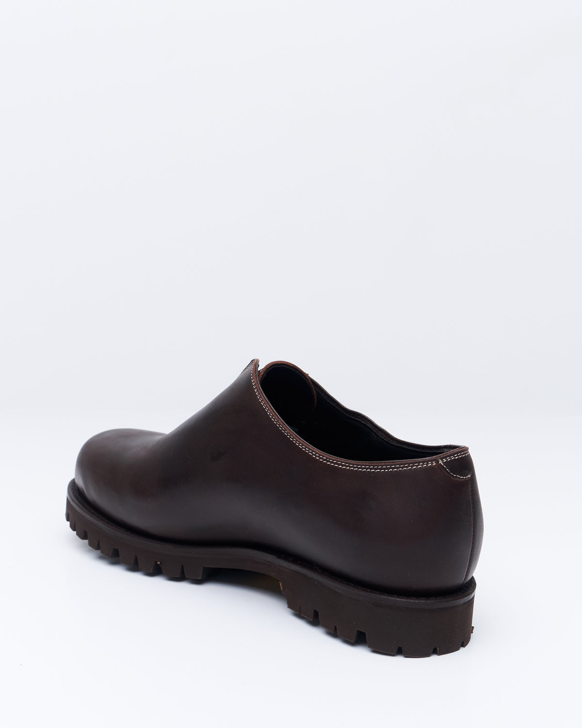 An Irrational Element Artist Shoe in chestnut leather, three-quarter back view with lug sole