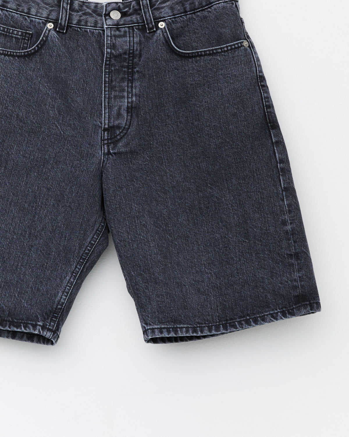 Another Aspect Denim Shorts 1.0 in faded black, front pocket and button fly close-up