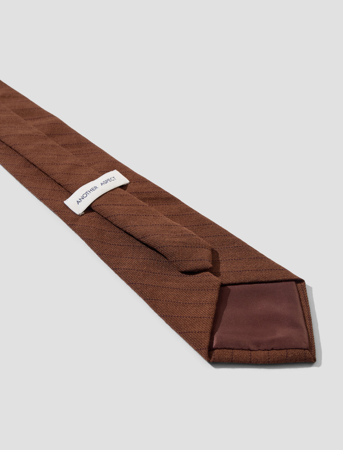 Another Aspect Tie 1.0 in brown stripe, label, keeper loop and lined tip close-up