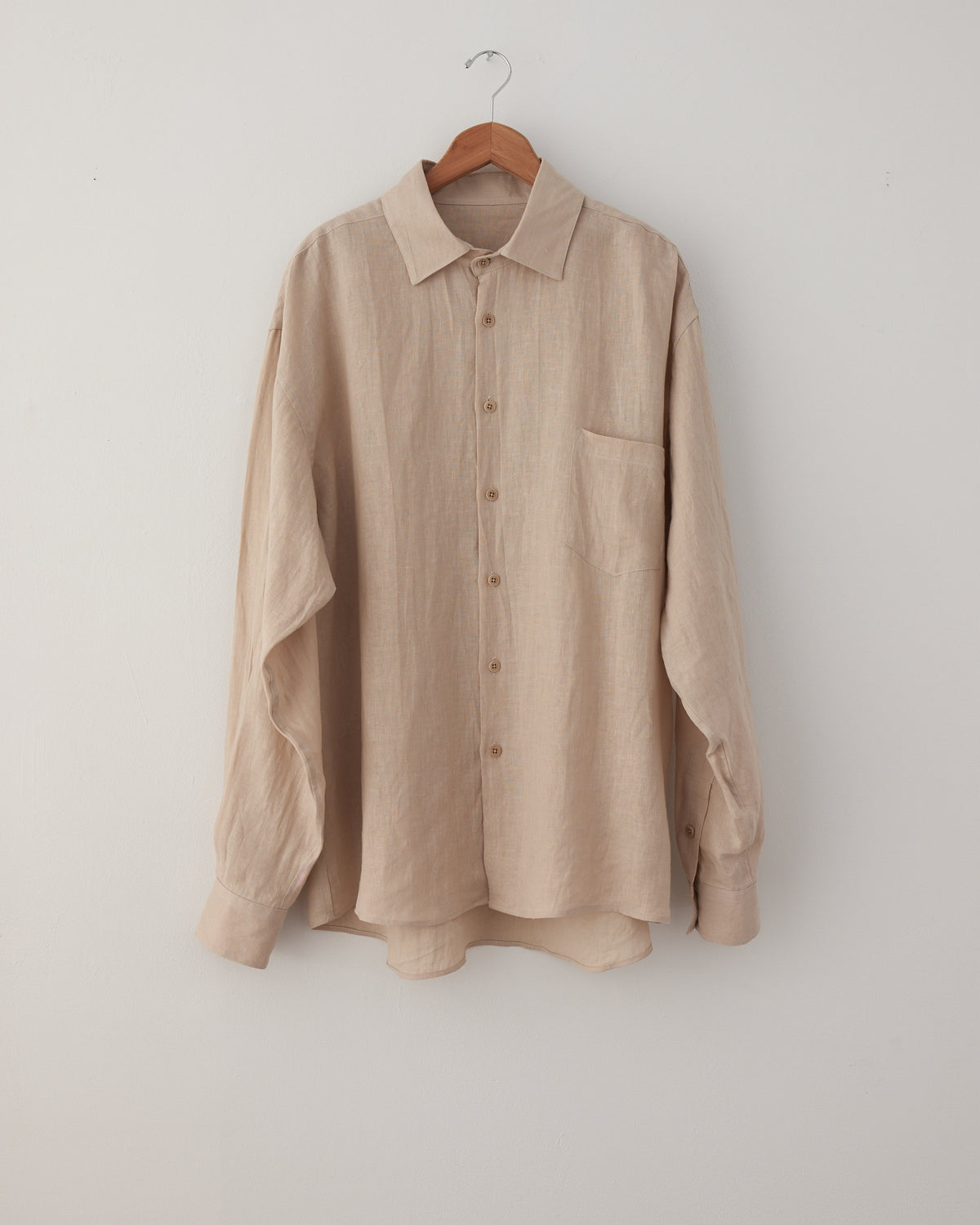 Colbo Banaras Shirt in natural Japanese linen, front, on a hanger