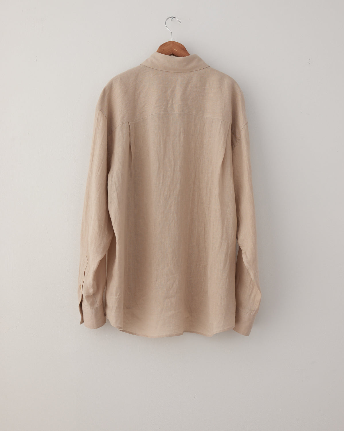 Colbo Banaras Shirt in natural Japanese linen, back, on a hanger