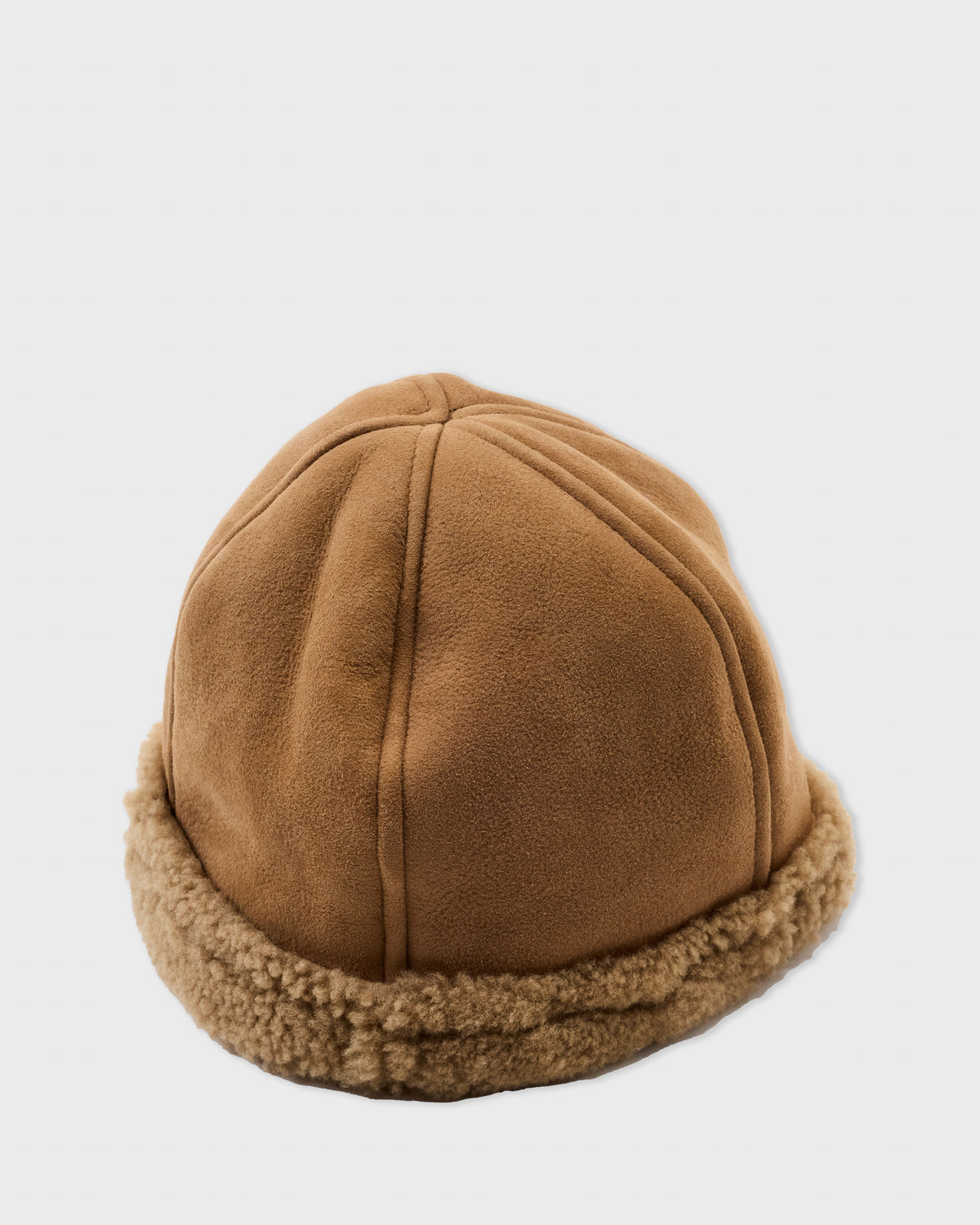 Cawley Francis Cap in tan sheepskin with a curly shearling brim