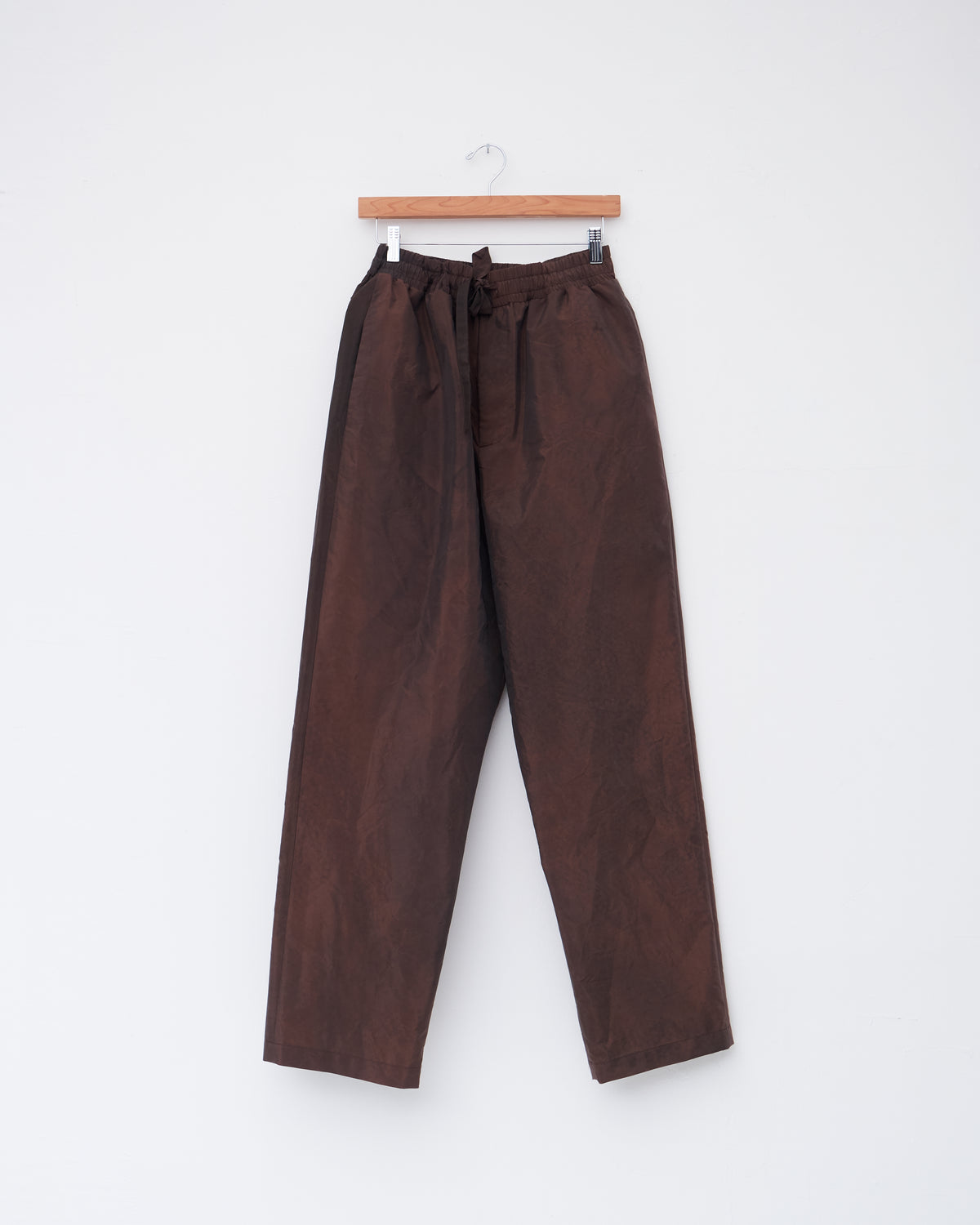 Colbo Draw Pants in washed burgundy Italian fabric, front, on a hanger
