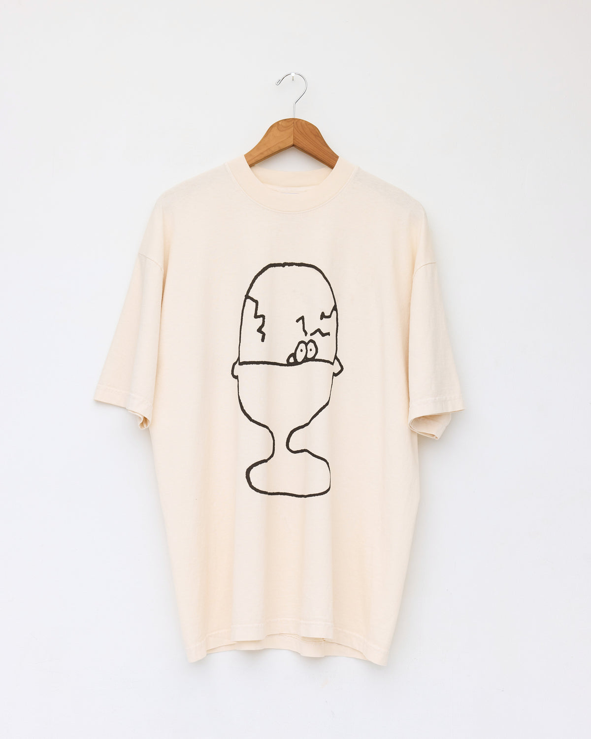 Colbo Frank & Tony graphic T-shirt in cream cotton, front, on a hanger, with hand-drawn graphic