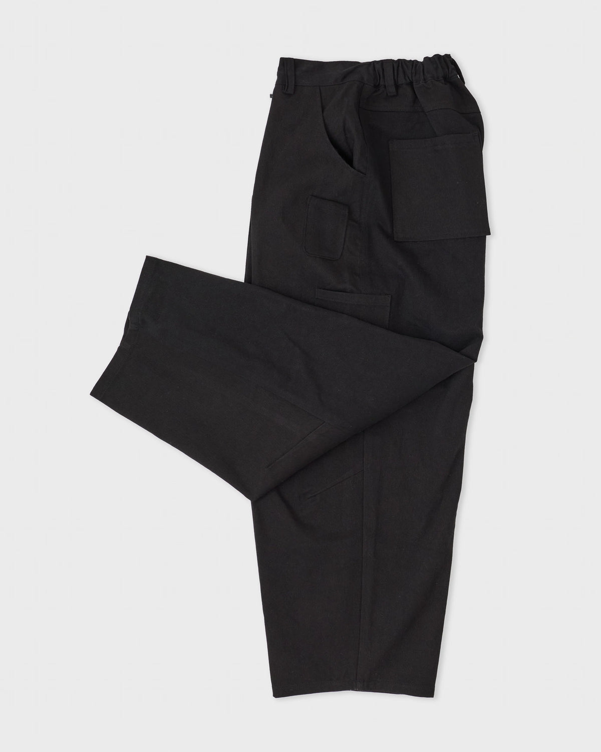 Estudio Niksen Mismatch Pocket Jeans in black denim, side, flat lay