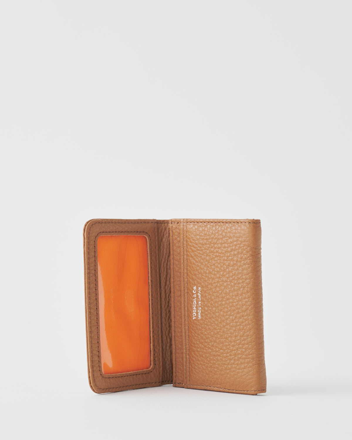 Porter Yoshida & Co. Calm Card Case in camel leather, open, showing ID window