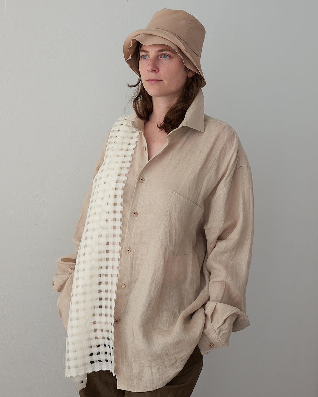 Colbo Banaras Shirt in natural Japanese linen, on model, front, styled with a bucket hat and mesh scarf