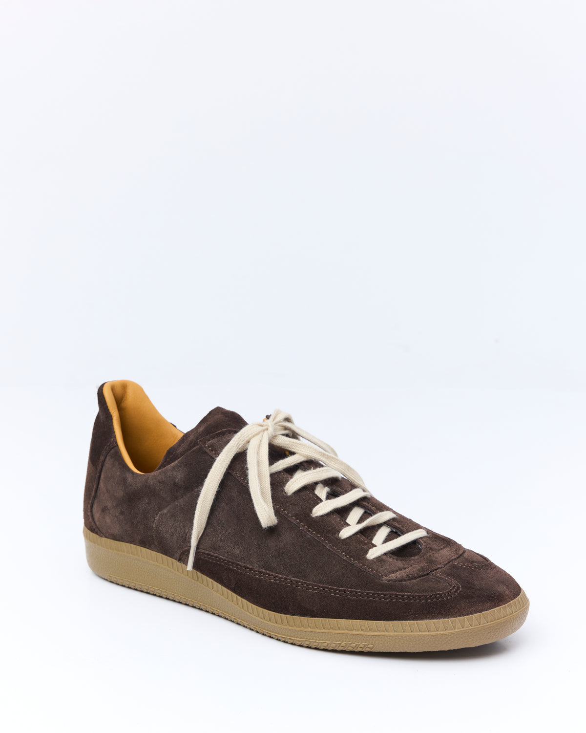 An Irrational Element Sculpture Trainer in chocolate suede, three-quarter view, shown with cream laces