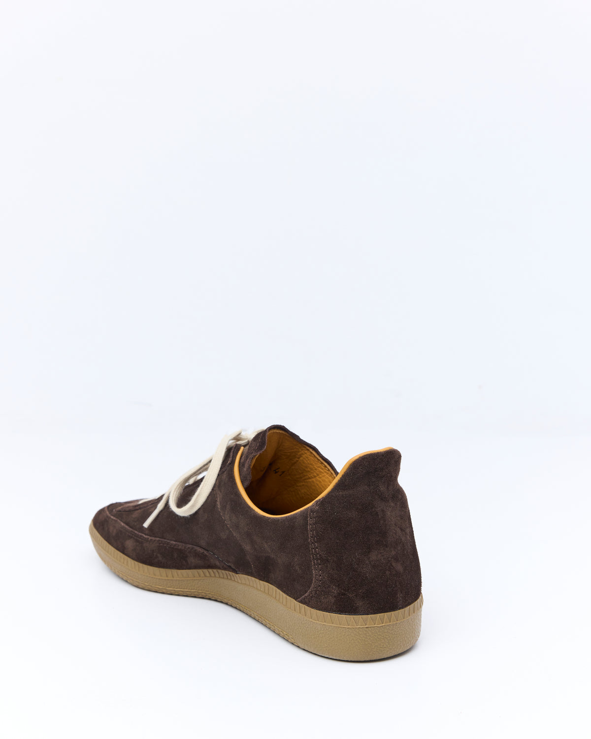 An Irrational Element Sculpture Trainer in chocolate suede, side view, shown with cream laces