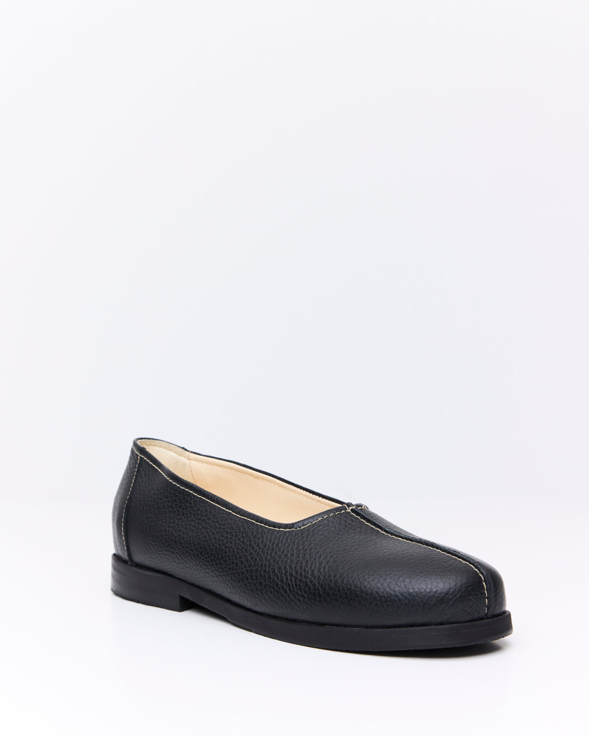An Irrational Element Simple Slip On Leather in black, three-quarter view