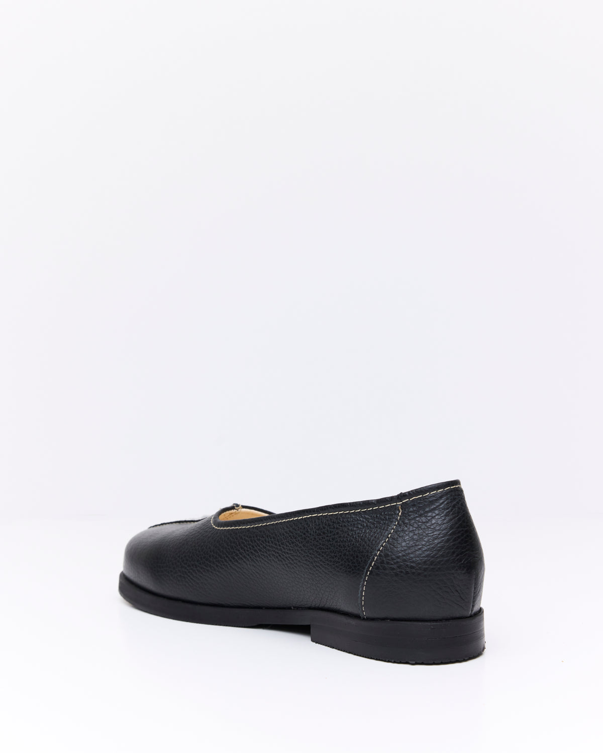 An Irrational Element Simple Slip On Leather in black, three-quarter back view
