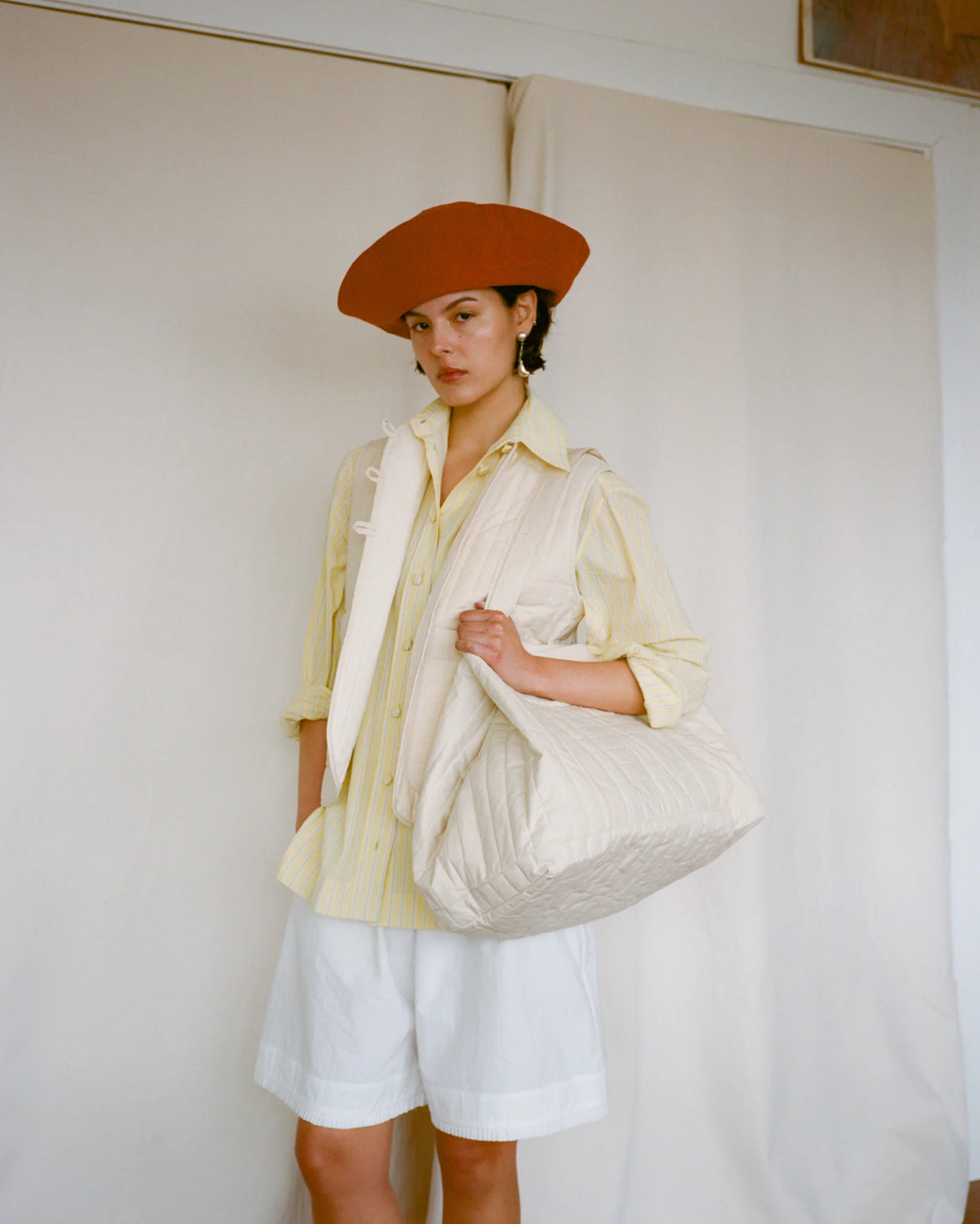 Cawley Quilted British Dry Oilskin Large Tote Bag in natural, on model, carried on the shoulder