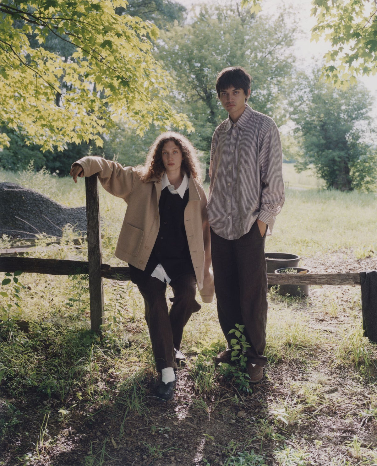 Two models by a fence in a field, one in the Colbo Steam Jacket in Beige