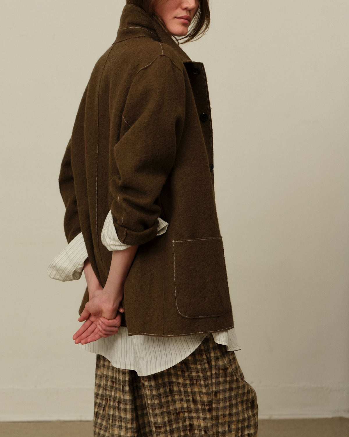 An olive wool jacket over a Colbo Triple Line Office Shirt and Tweed Check Light Pants