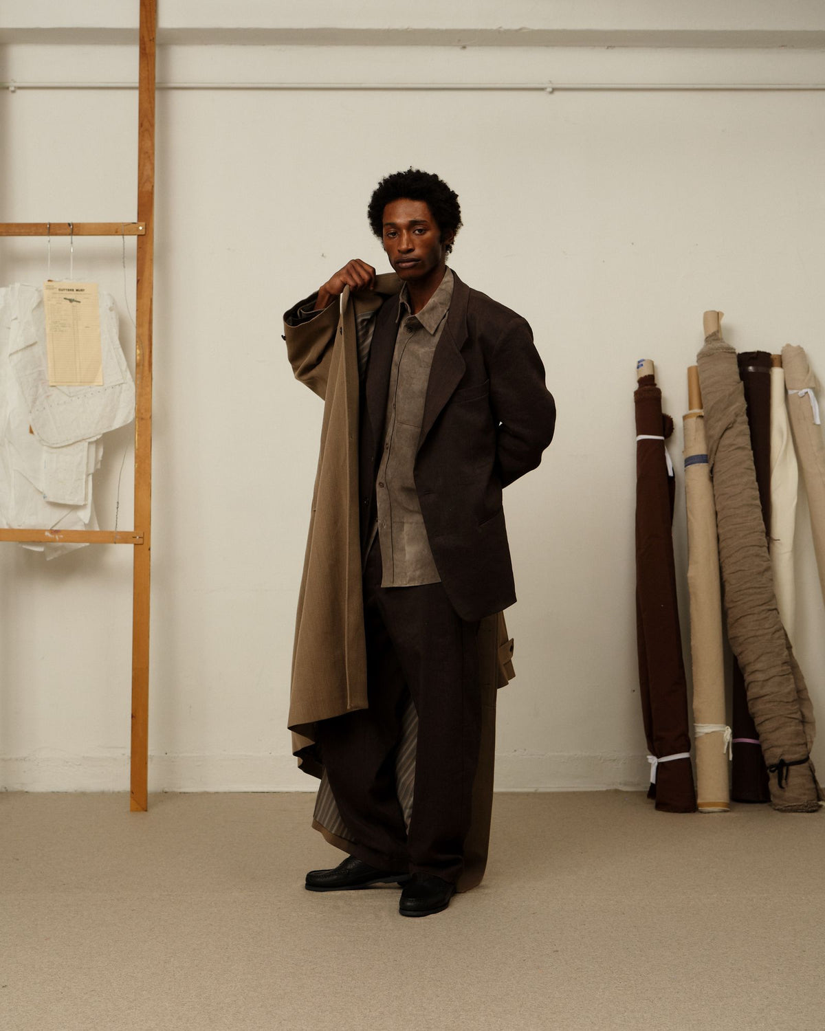 A model in the Colbo TK Shirt in Cold Dyed Greige under a brown blazer