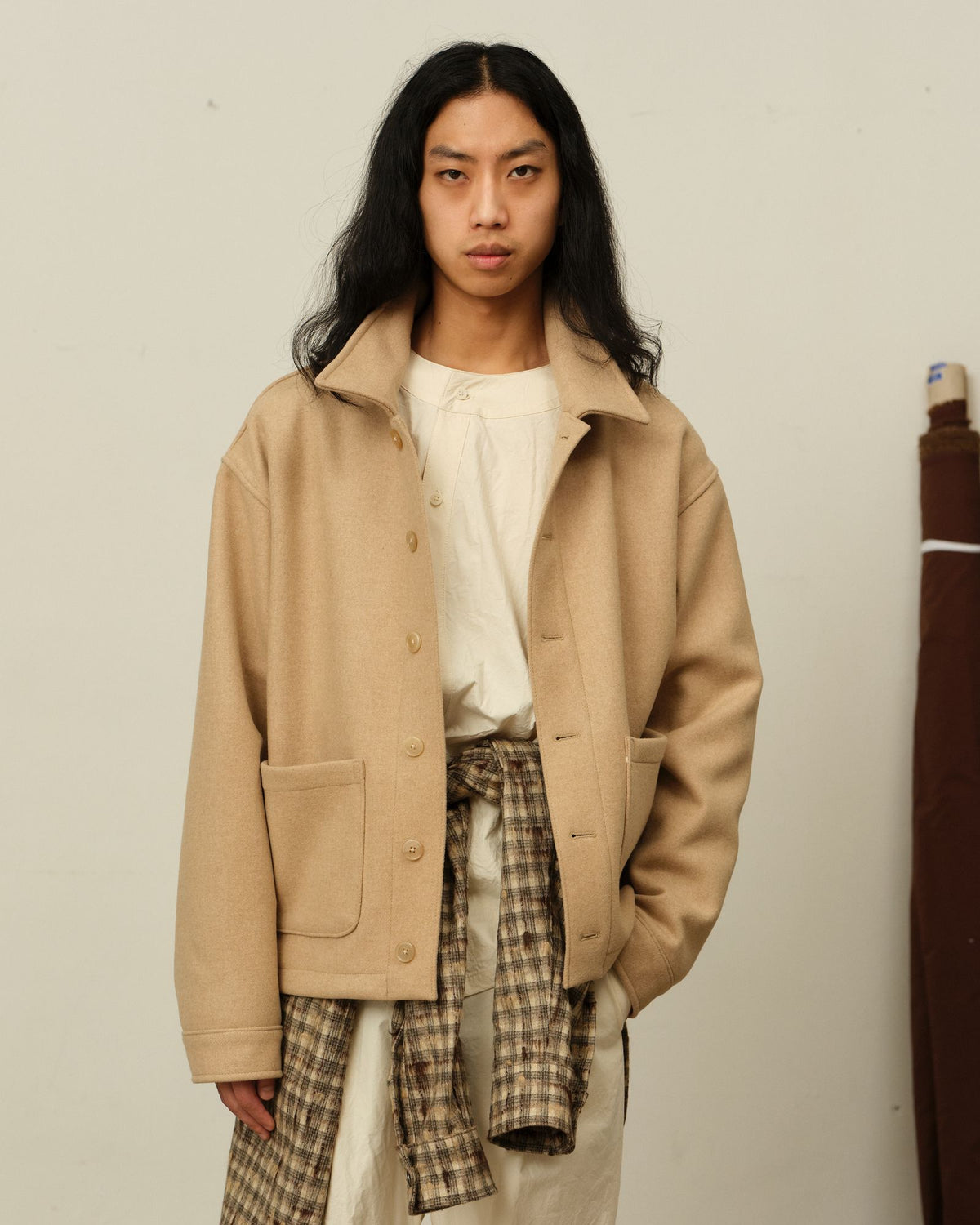 The Colbo Steam Jacket in Beige, with a Tweed Check Hooded Shirt tied at the waist