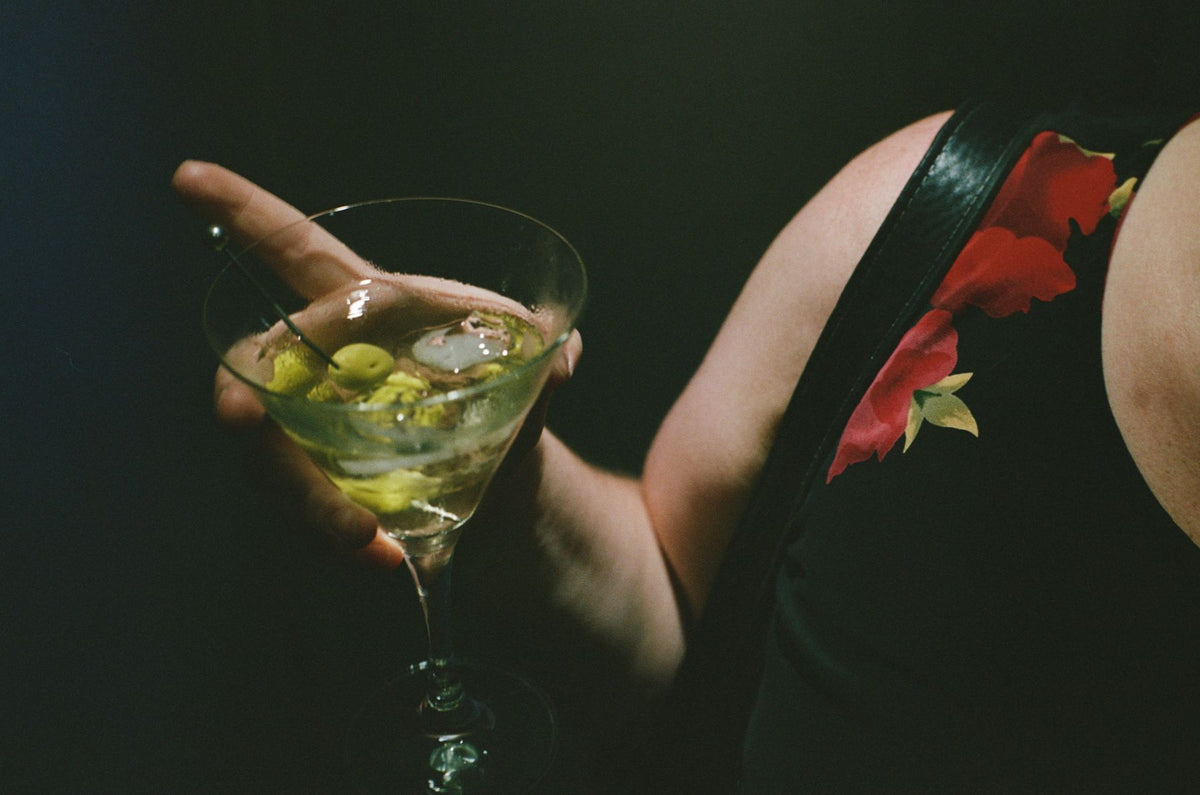 A martini with olives in hand at a Colbo evening