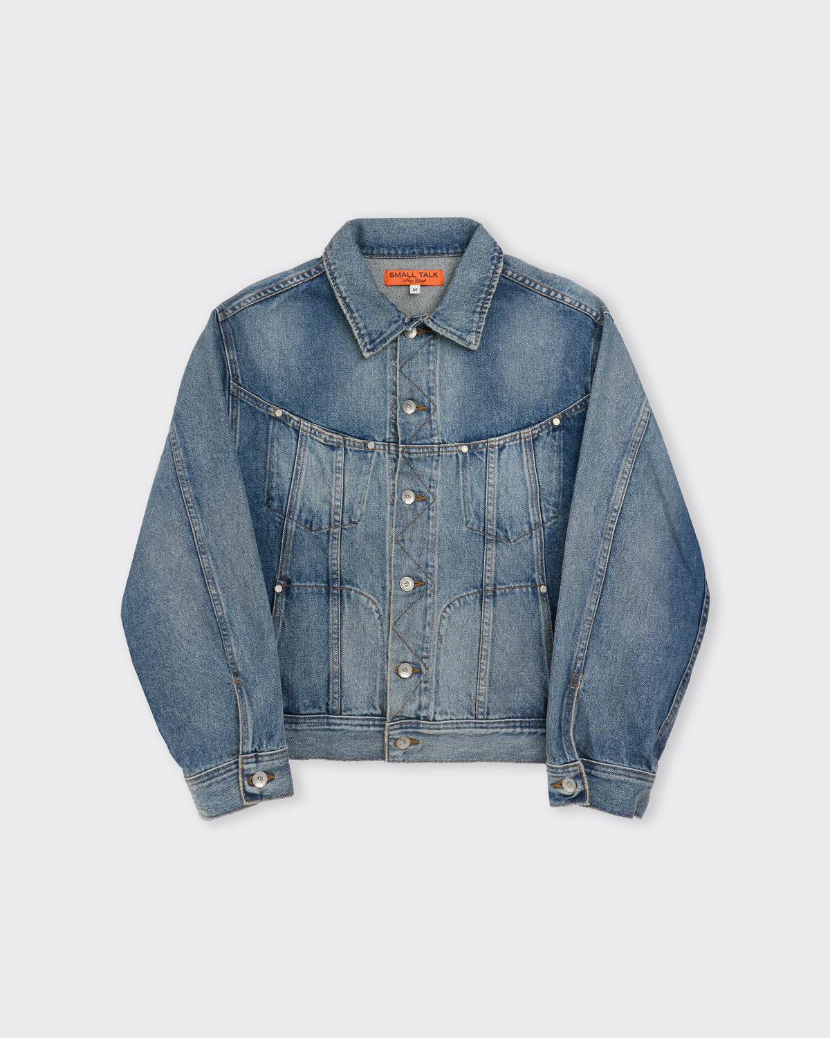 Small Talk Studio Twist Trucker Jacket in washed indigo, front