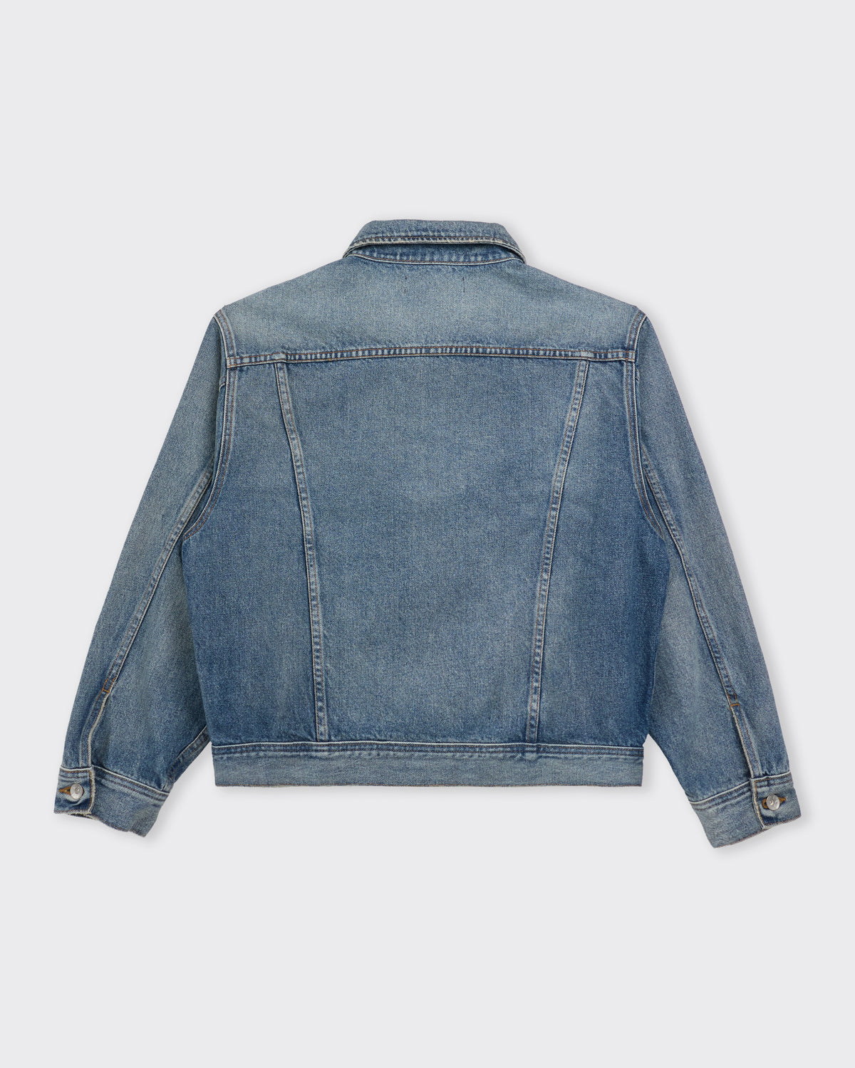 Small Talk Studio Twist Trucker Jacket in washed indigo, back