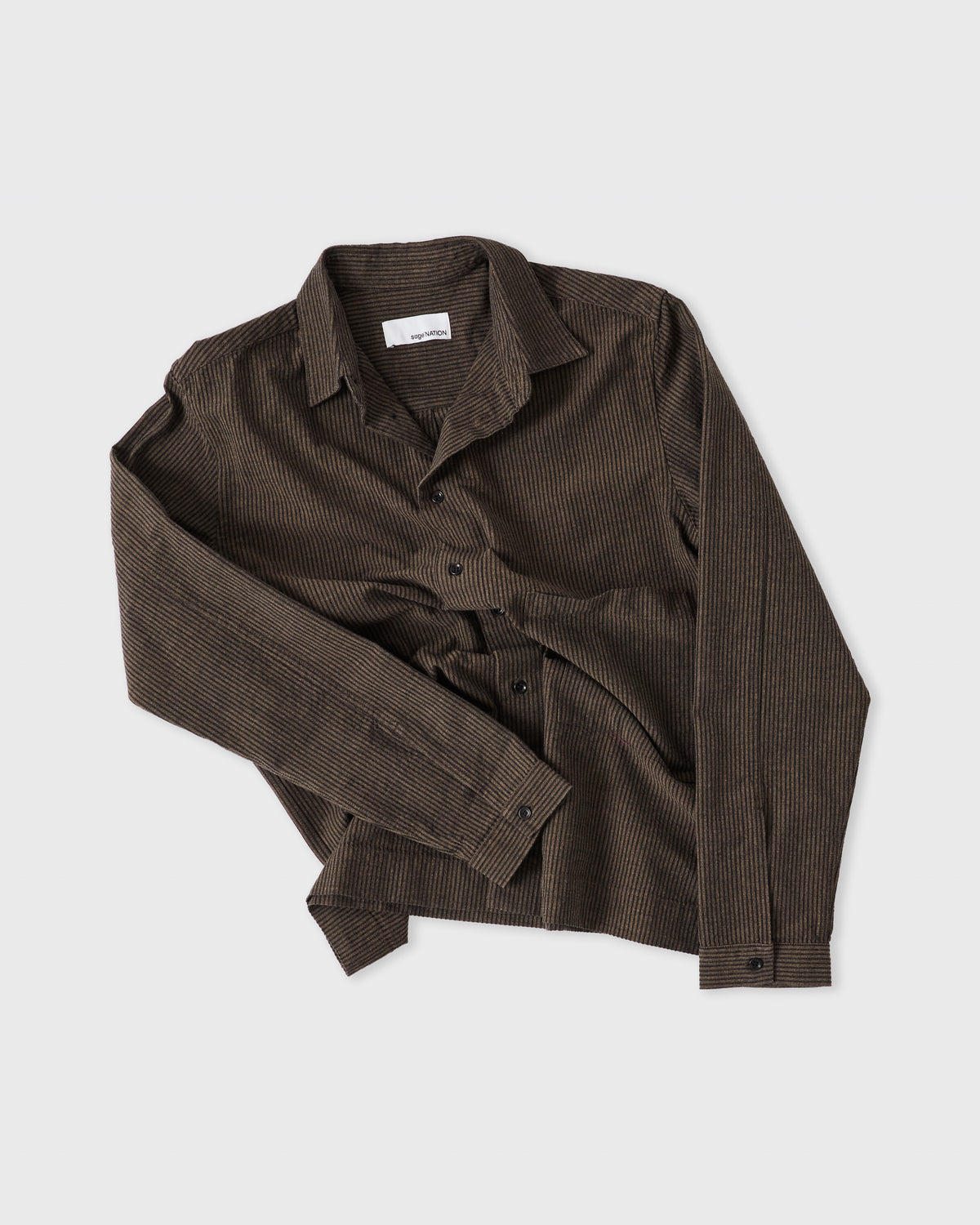 Sage Nation Natal Shirt in brown and navy stripe cotton-wool, loosely folded flat lay