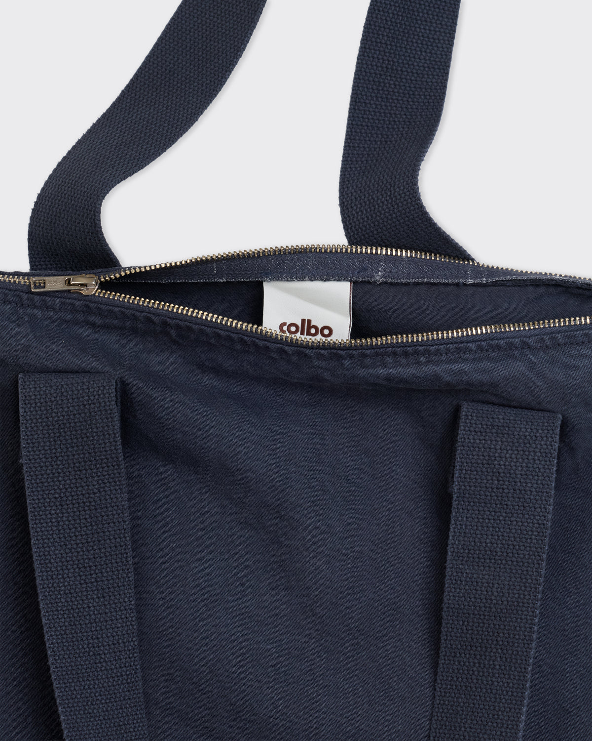 Colbo Zip Tote Bag in navy cotton, zip top and Colbo label close-up