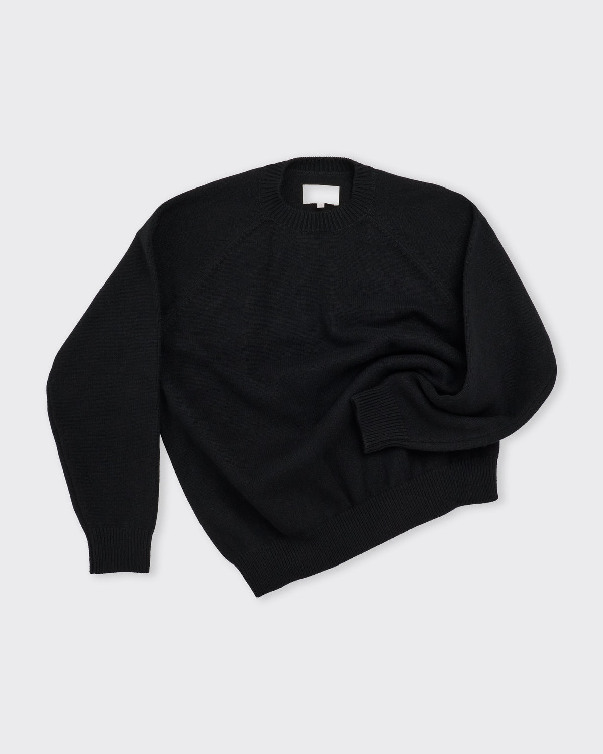 Yoko Sakamoto Raglan Crew Neck Knit in black, three-quarter view