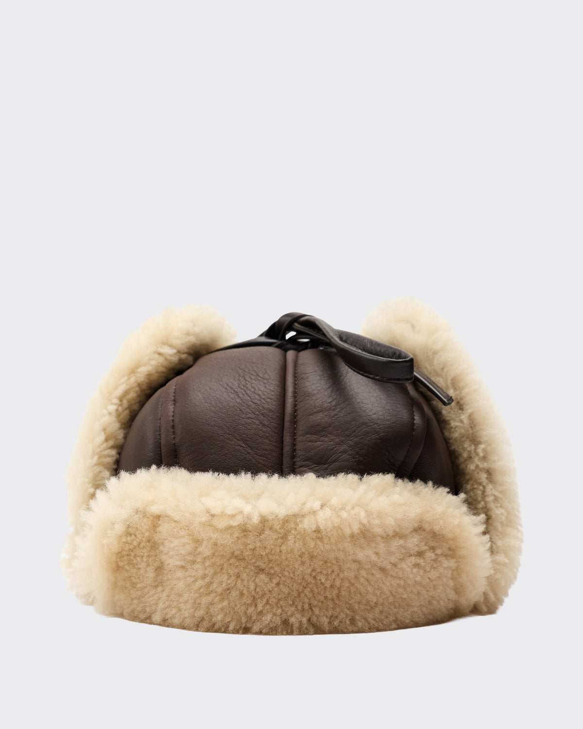 Cawley Leather Back Curly Hair Sheepskin Trapper Hat in chocolate/cream, ear flaps tied up