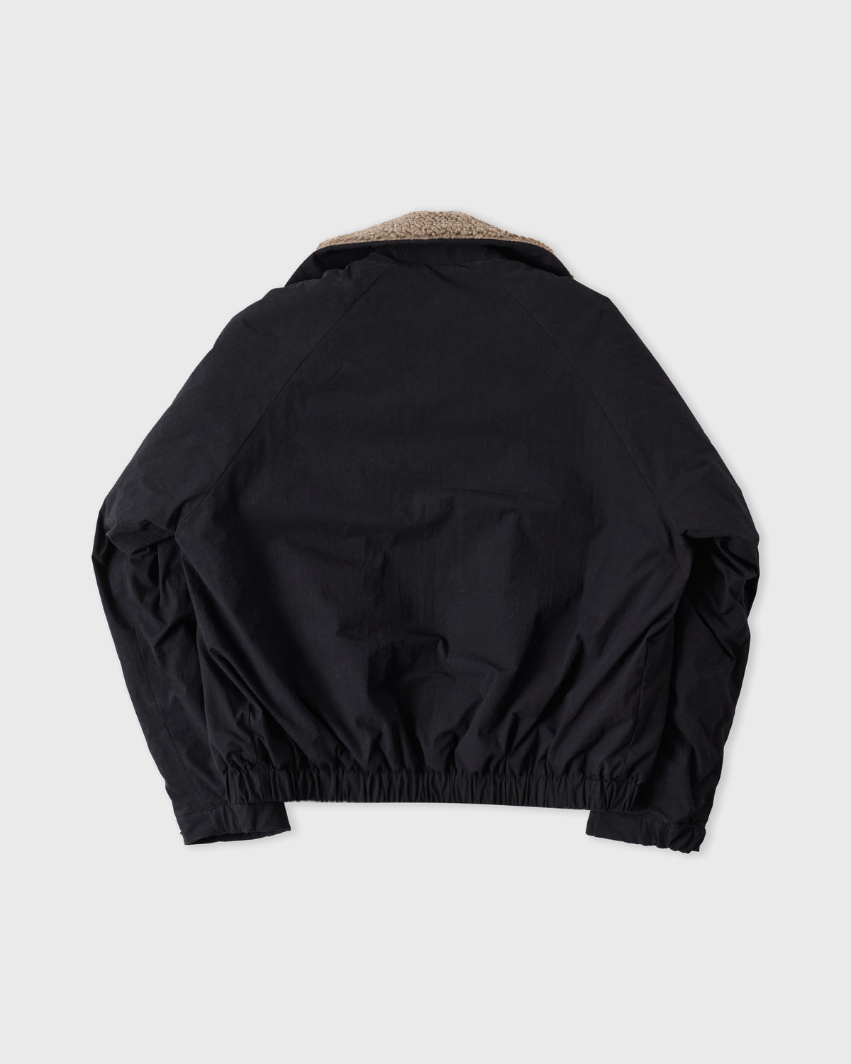 Sage Nation Toya Bomber in dark navy cotton-nylon, back, flat lay