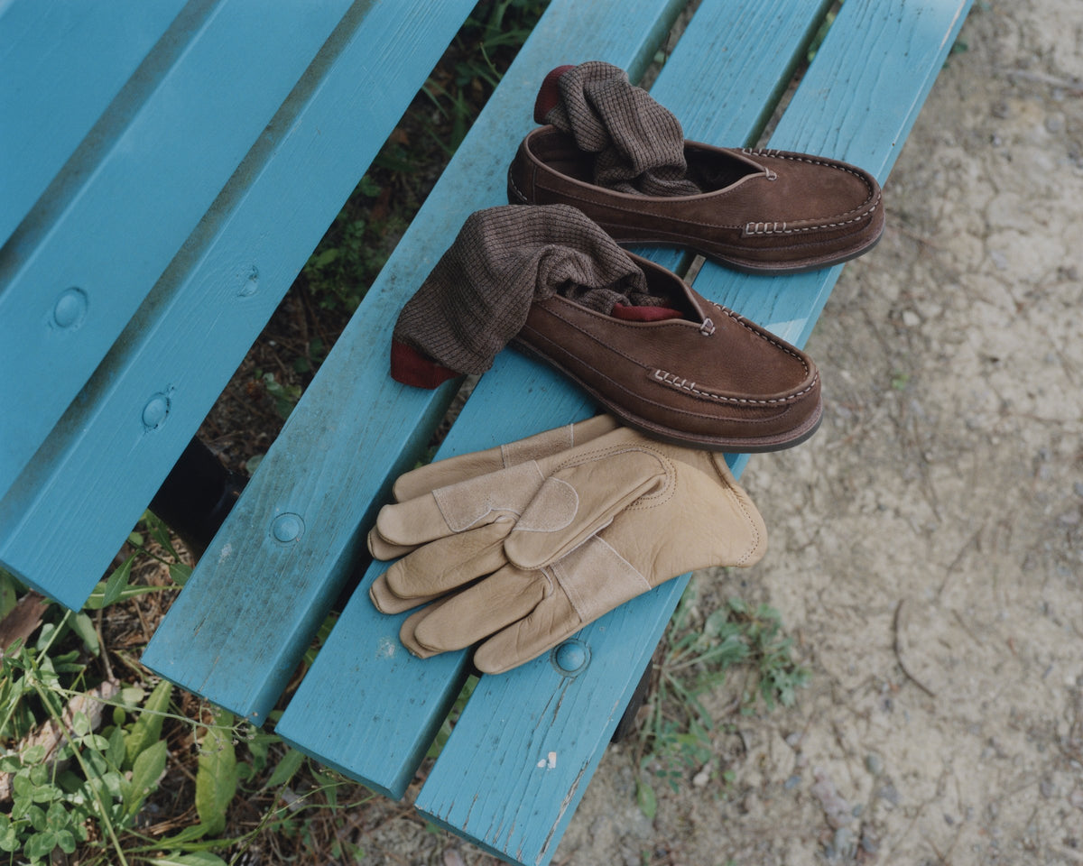 Earth Sirah loafers and suede gloves on a blue bench