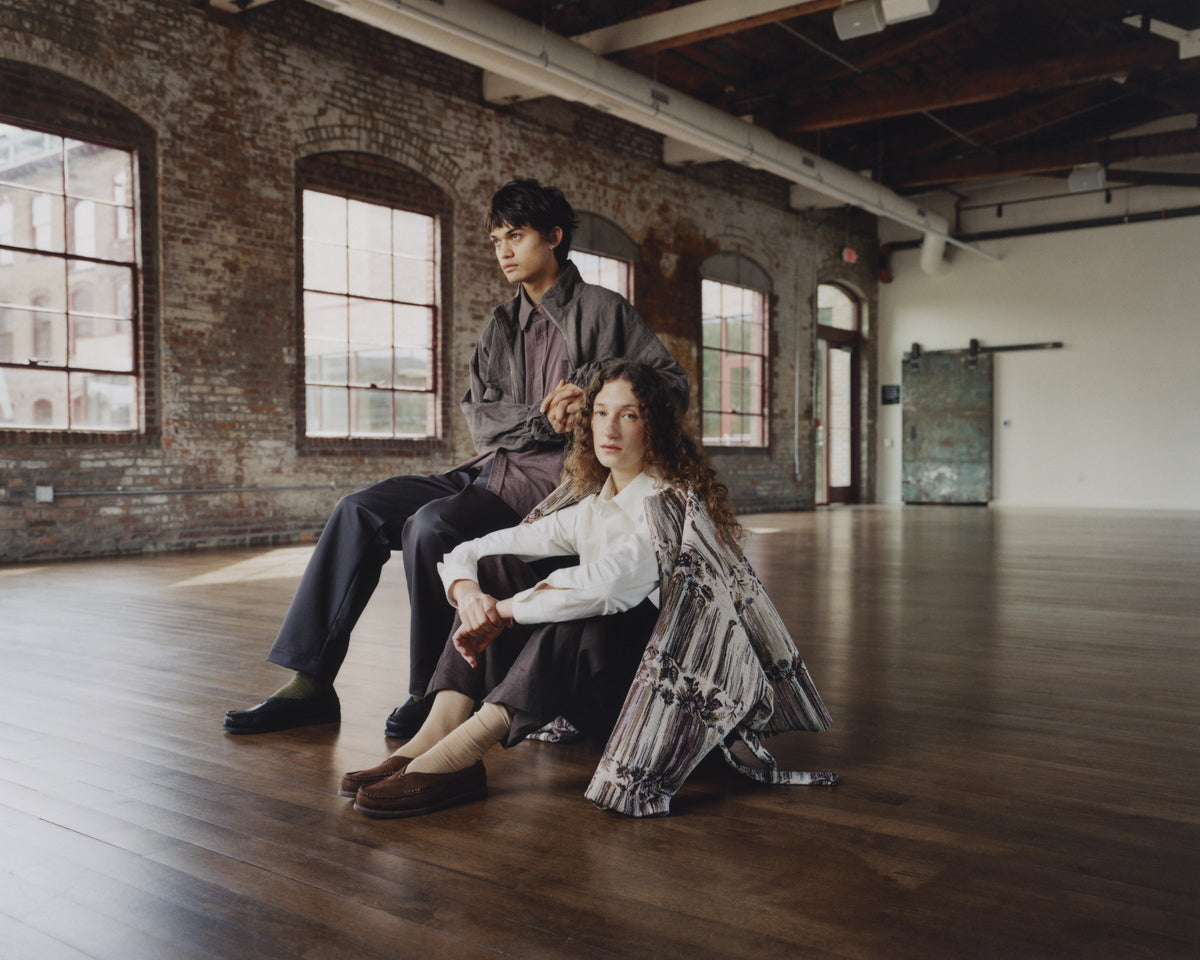 Two models on the floor of a brick loft at Pocketbook Hudson