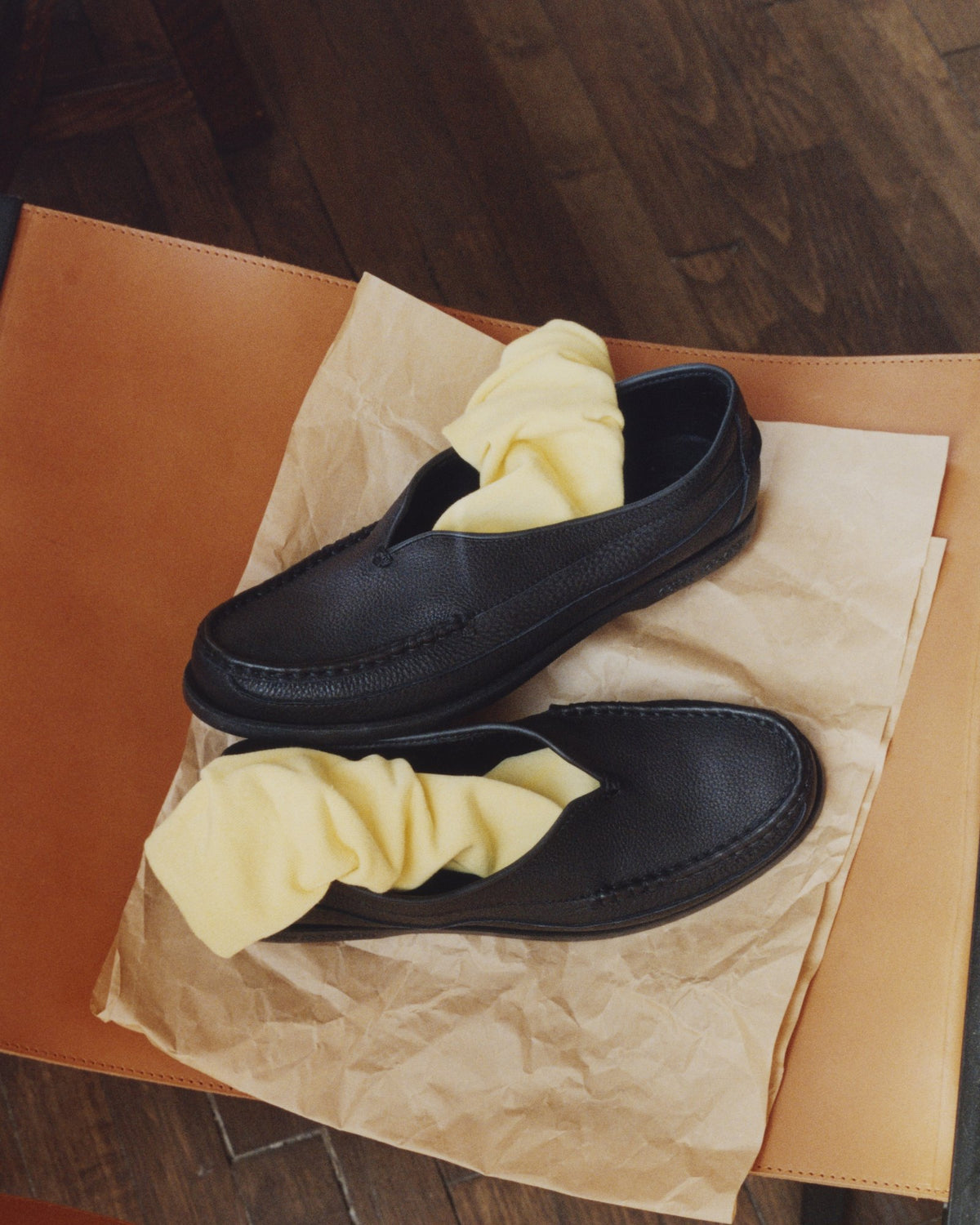 A pair of black Sirah loafers on tissue paper